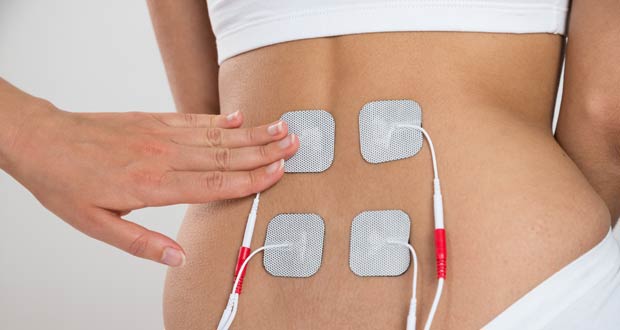 Chiropractor Administering TENS Therapy