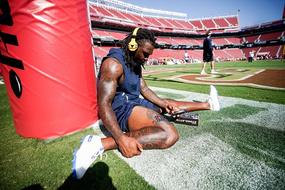 Kavon Frazier professional NFL player for the Dallas Cowboys warming up with PlayMakar SPORT muscle stimulator